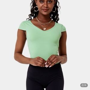 HALARA seafoam green sports top, w/ open back cut outs, fits small